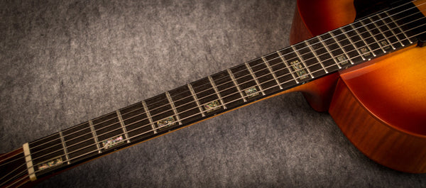 archtop guitar with inlay on fret boards 